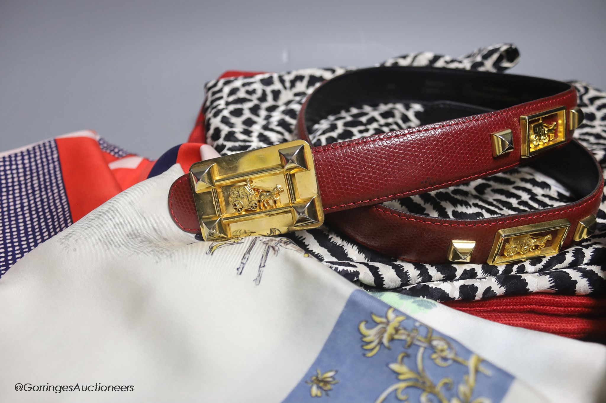 An Yves Saint Laurent black and white animal print silk top, a Laure de France leather belt and four vintage designer silk scarves